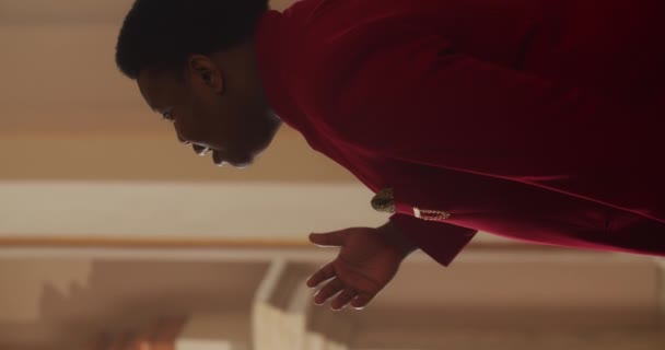 Side view of talanted african american gospel musician in red suit singing. Young man emotionally performing worship music and moving body in rhytm .Vertical video. - Felvétel, videó