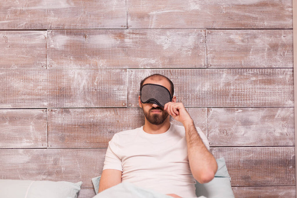 Caucasian man pulling his sleep mask - Photo, Image