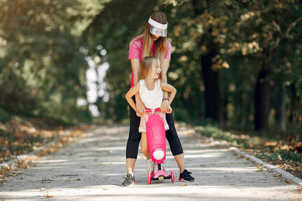Mother with daughter playing in a summer park - Foto, Bild