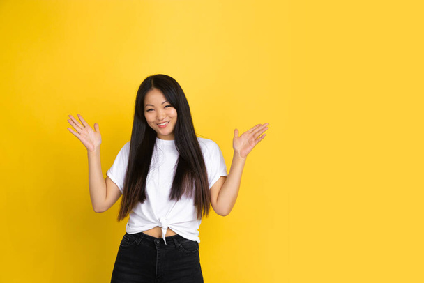 Portrait of young asian woman isolated on yellow studio background - Fotoğraf, Görsel