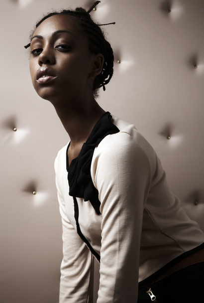 Close-up portrait of Beautiful African woman pose on a beige leather backgr - Φωτογραφία, εικόνα