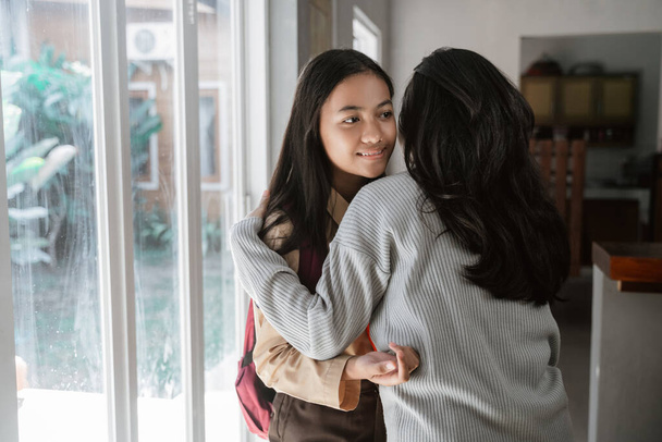 mother embrace daughter before leaving to school - Foto, imagen