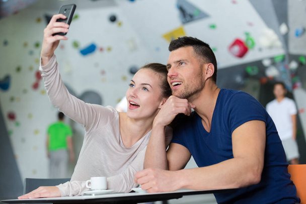 couple taking selfie at indoor sports center - Photo, Image