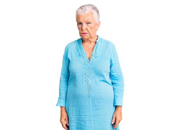 Senior beautiful woman with blue eyes and grey hair wearing summer dress skeptic and nervous, frowning upset because of problem. negative person.  - Photo, Image