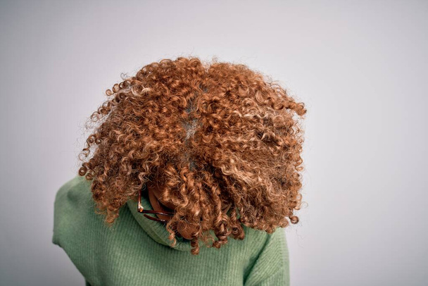 Молода африканська американка, одягнена в пластмасовий светр і скло Страждає від болю у спині, торкаючись руками і м'язовим болем. - Фото, зображення