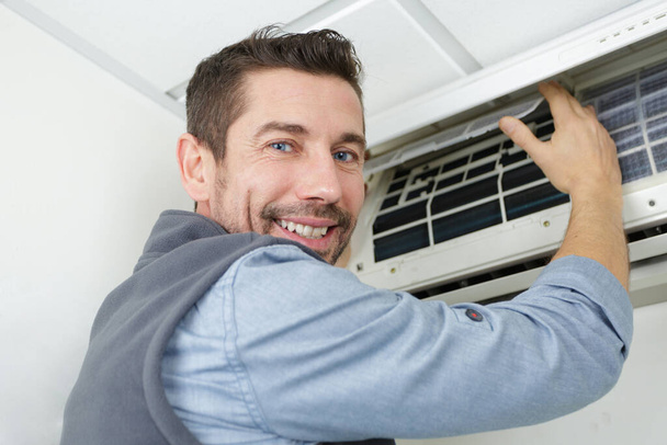 portrait of a man working on air-conditioned system - Фото, зображення
