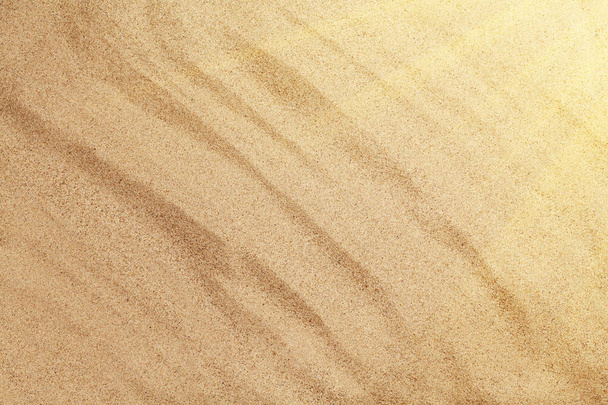Hot sea sand texture background. Sunny beach backdrop. Top view with copy space - 写真・画像