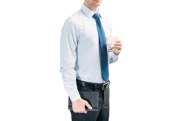 A guy in a white shirt and blue tie on a white background. A man holds a glass with a cocktail and in his second hand is a notebook. Businessman. Author. - Foto, Imagen