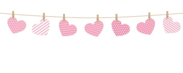 pink hanging hearts on a rope on white background - Vektor, kép