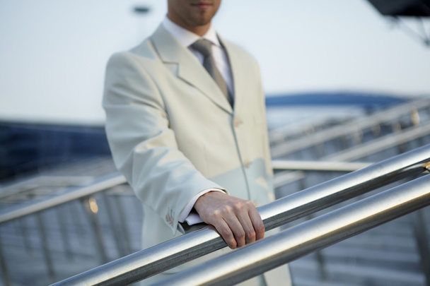 Hand of man in a classic suit keeps for a handrail - Fotoğraf, Görsel
