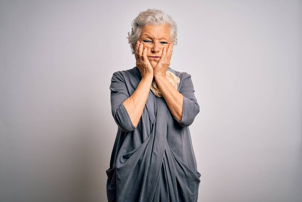 Senior beautiful grey-haired woman wearing casual dress standing over white background Tired hands covering face, depression and sadness, upset and irritated for problem - Φωτογραφία, εικόνα