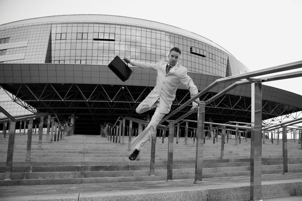 Young businessman with briefcase running on stair - Fotografie, Obrázek