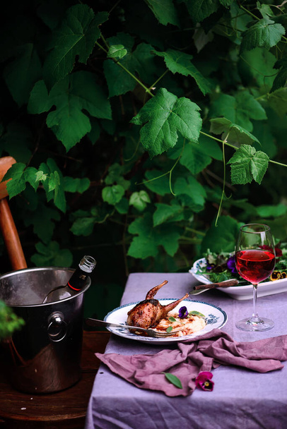 Quail with polenta and cranberry sauce.outdoor photo.style rustic.selective focus - 写真・画像