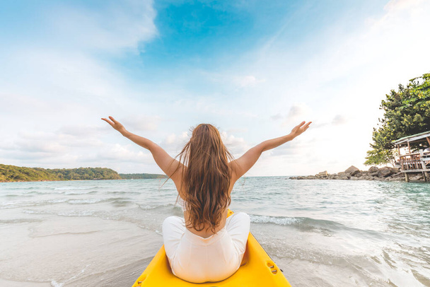 Back of view woman kayaking enjoy with summer vacation on the beach feeling so happiness and cheerful,Travel in tropical beach in Thailand,vacations and relaxation Concept - Photo, image