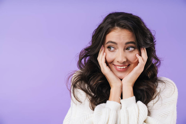 Image of cheerful happy young brunette woman posing isolated over purple wall background looking aside. - Φωτογραφία, εικόνα