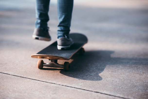 Skateboarder legs skateboarding at outdoors in the parking lot - Фото, зображення