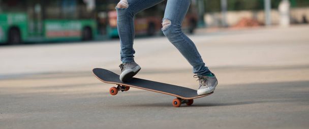 Skateboarder legs skateboarding at outdoors in the parking lot - Photo, Image