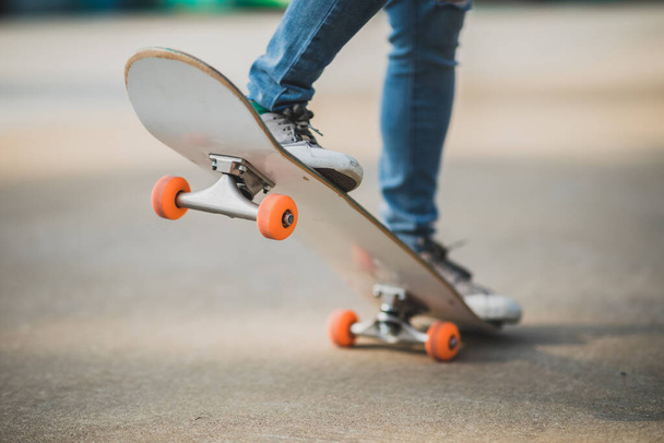 Skateboarder legs skateboarding at outdoors in the parking lot - Fotó, kép