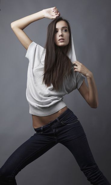 Sensual girl posing. Studio shot on gray background. - Fotó, kép