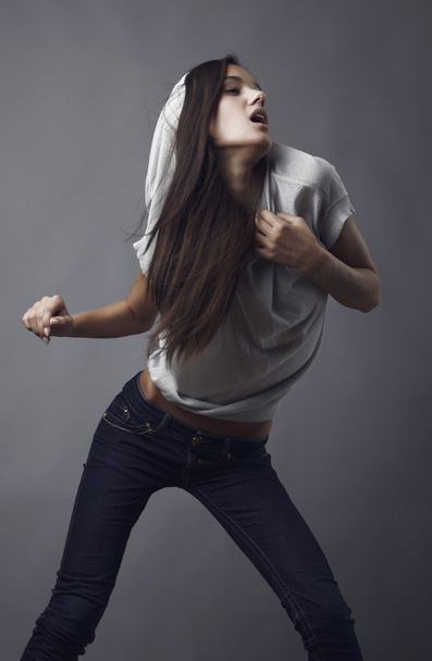 Sensual girl posing. Studio shot on gray background. - Foto, afbeelding