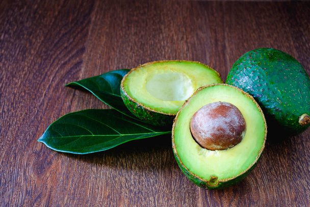 Avocado fruits and leaves on wooden boards. - Photo, Image
