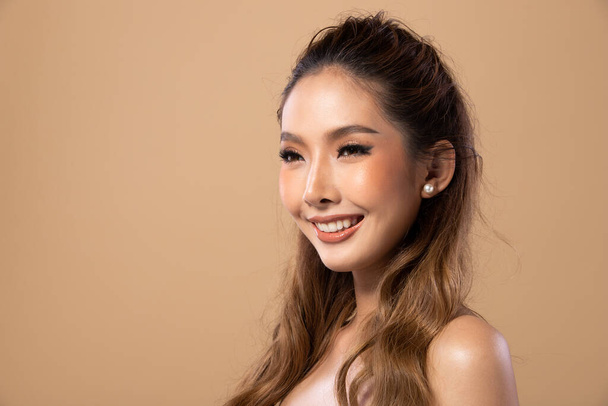 Fashion Asian Woman slim has beautiful brown blonde dying curl hair style from Stylish. Girl wears cream dress over Beige yellow Background copy space - 写真・画像