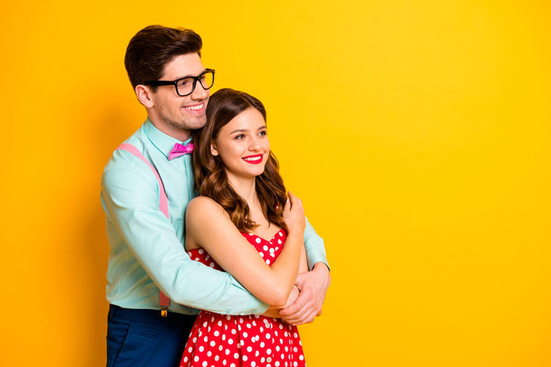 Profile photo of attractive pretty lady handsome guy couple hugging look side empty space wear red dotted dress shirt bowtie retro clothes isolated yellow bright color background - Φωτογραφία, εικόνα