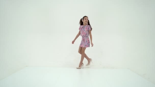 Cheerful little girl in large shoes taken from her mother. - Imágenes, Vídeo