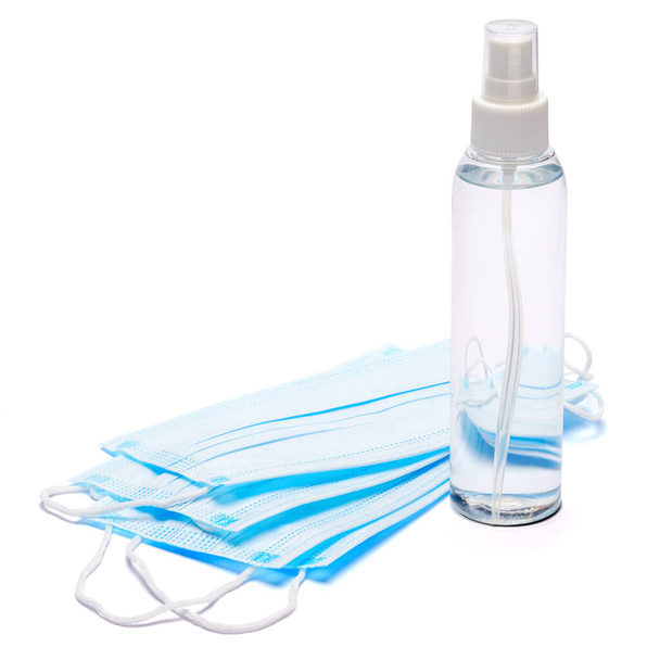 White bottle of cream, lotion, sanitizer or liquid soap and protective mask isolated on white background - Valokuva, kuva