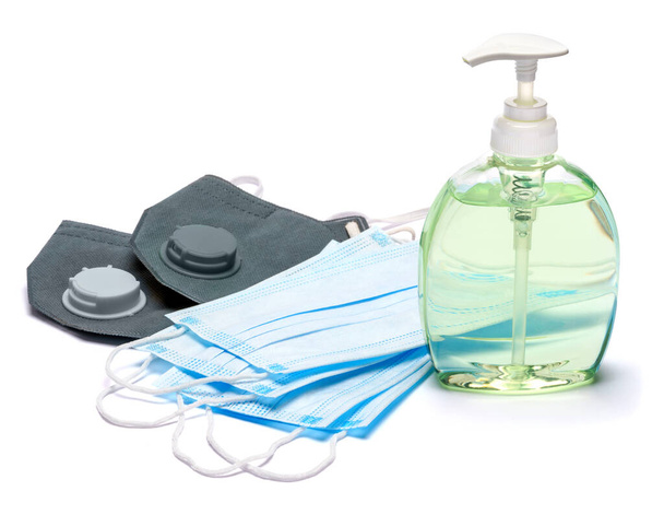 White bottle of cream, lotion, sanitizer or liquid soap and protective mask isolated on white background - Photo, Image
