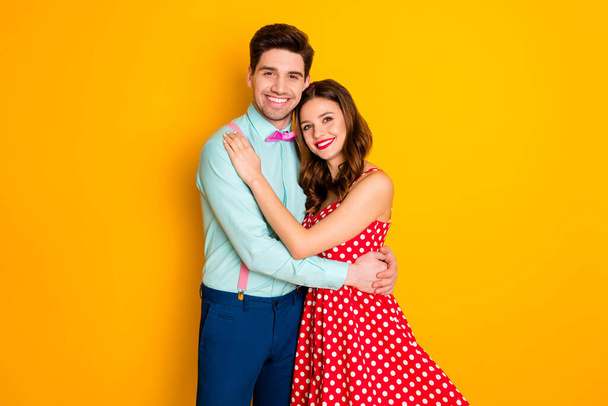 Photo two people attractive lady handsome guy prom party couple hugging posing portrait wear red dotted dress shirt bowtie retro clothes isolated yellow bright color background - Fotó, kép