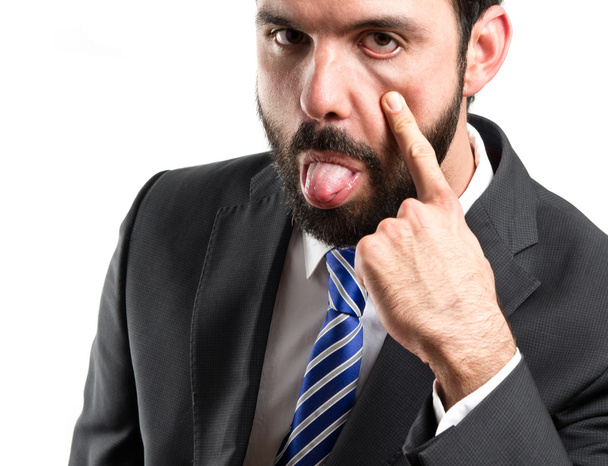Young businessman making a mockery over white background - Photo, Image
