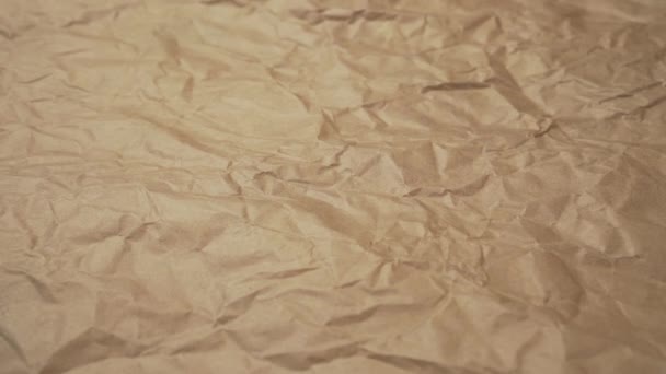 Crumpled paper. Packaging brown shabby material. Abstract textured background. Slow Track Camera - Footage, Video