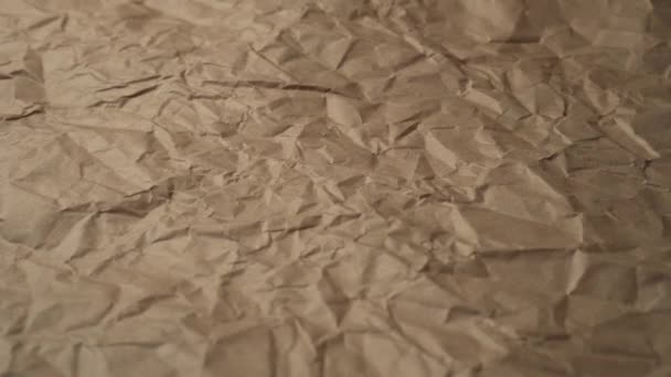 Closeup crumpled wrapping brown paper with wrinkles and scuffs. Slow Track Camera - Video