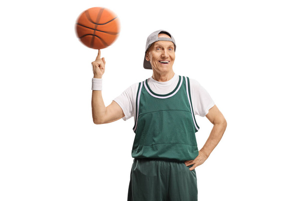 Elderly man spinning a basketball isolated on white background - Foto, Imagen