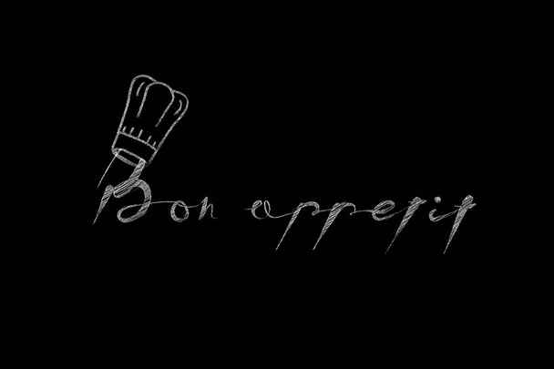 Bon appétit mots avec chapeau de cuisine sur un fond noir. Image vectorielle - Vecteur, image