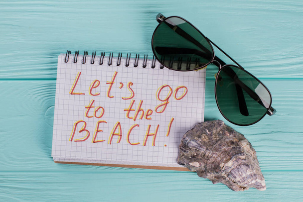 Tropical beach concept made of sea shell and sun glasses. - Photo, Image