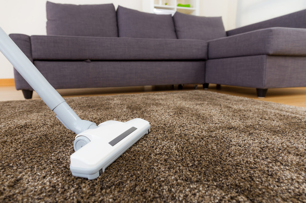 Carpet with vacuum cleaner in living room - Photo, Image