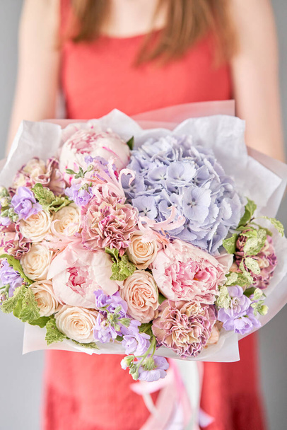 Beautiful bouquet of mixed flowers in woman hand. Floral shop concept . Handsome fresh bouquet. Flowers delivery. - Valokuva, kuva