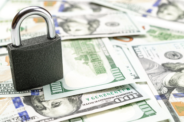 Save money concept. Washington American cash with padlock isolated on white. Usd money background. - Fotó, kép