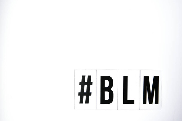 hashtag BLM BLACK LIVES MATTER text on a white background. Protest against the end of racism, anti-racism, equality. Poster on violation of human rights - Фото, изображение