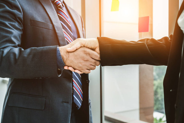 Business people handshake in corporate office showing professional agreement on a financial deal contract. - Fotoğraf, Görsel
