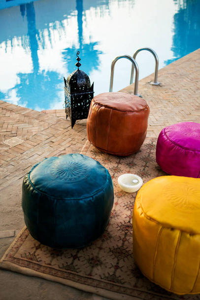Moroccan traditional multicolored leather poufs on the carpet, Moroccan decor - Photo, Image