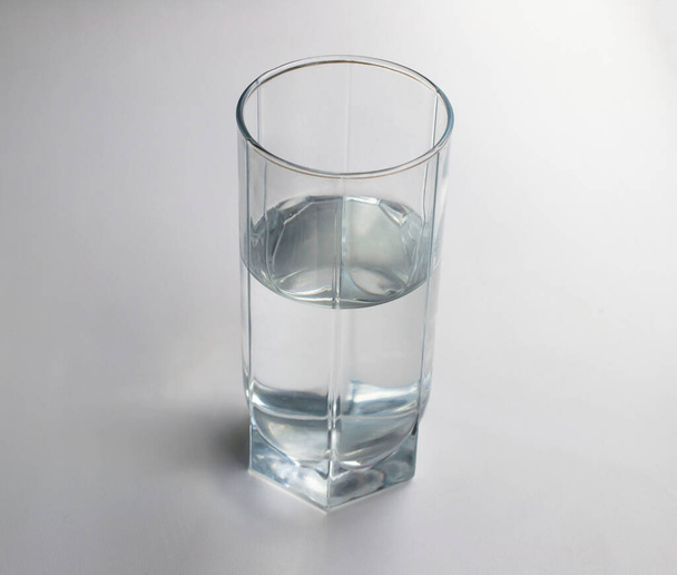glass with clean water on a light background. close-up - Photo, Image