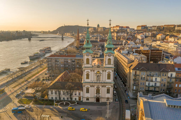 Aerial drone shot of facade of St. Anne Parish church during Budapest sunrise in winter - Photo, Image