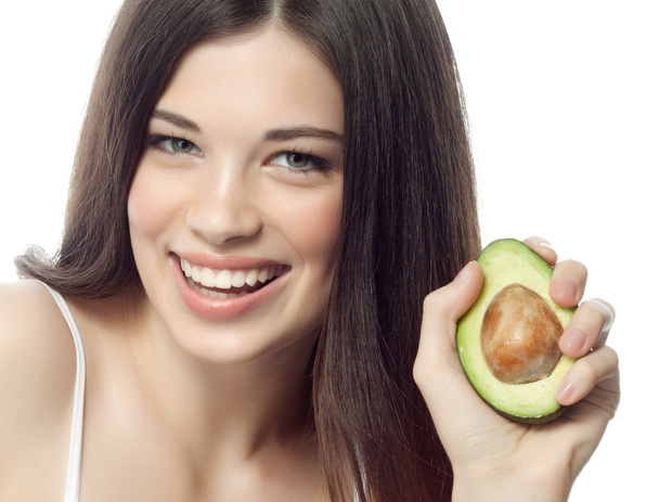 Smiling woman with with avocado - Foto, afbeelding