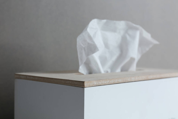 Holder with paper tissues on grey background, closeup - 写真・画像