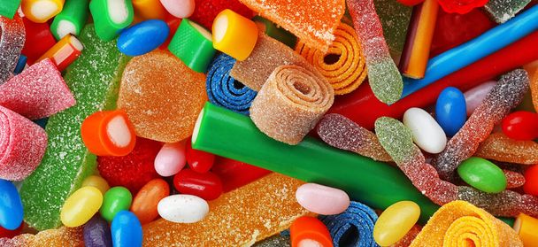 Delicious colorful chewing candies as background, top view. Banner design  - 写真・画像