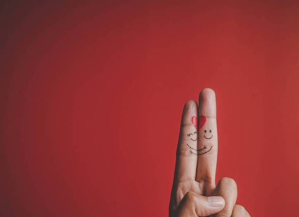 Finger with emotion on red background - Photo, Image