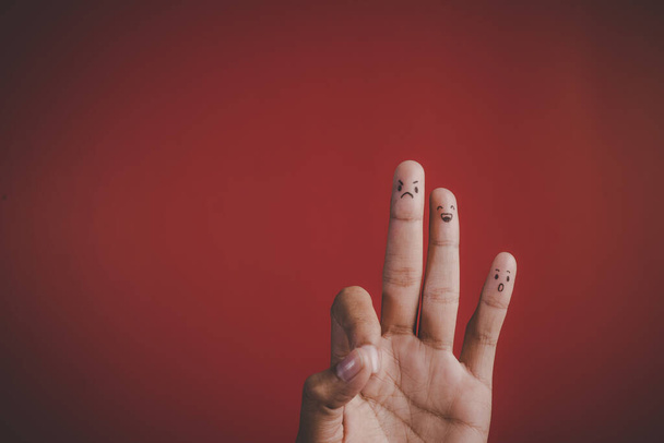 Finger with emotion on red background - Photo, Image